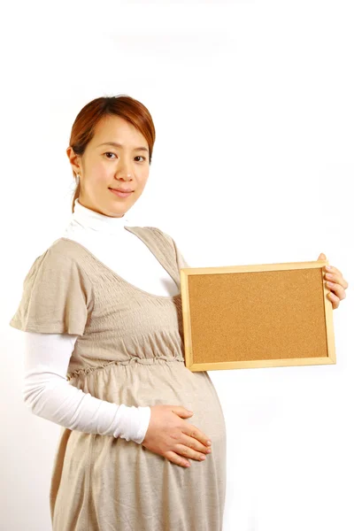 Pregnant woman with massage board　 — Stock Photo, Image